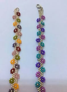 two bracelets with beads and flowers on them