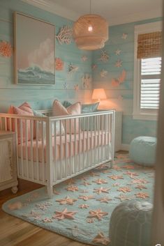 a baby's room decorated in pastel blue and pink with starfish wallpaper