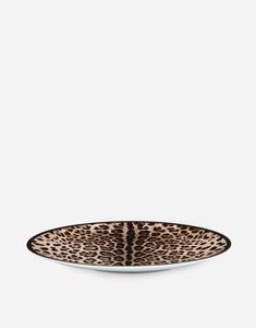 a leopard print plate on a white background