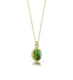 This piece just glows! The green tourmaline is wrapped in a 14K green gold bezel and the pairing of stone and metal is divine. This pendant, with its verdant color, is one of our favorites. Our signature Cashmere Finish® gives a softness to the metal and makes the stone sing. More like this: Tourmaline Cabochon Rings PRODUCT SPECIFICATIONS: Stone is 3.66ct and approximately 10x8mm Chain is 18" long Luxury Green Round Stone Necklace, Tourmaline Jewelry Round, Green Round Stone Necklace, Luxury Spiritual Tourmaline Necklaces, Luxury Green Stone Setting Necklaces, Luxury Green Necklace With Round Stone, Cheap Green Stone Jewelry, Luxury Green Pendant Jewelry, Luxury Green Domed Jewelry