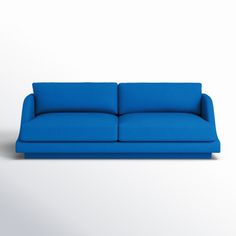 a blue couch sitting on top of a white floor