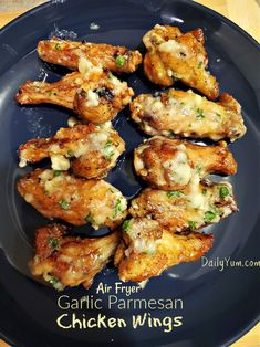 grilled chicken wings with garlic and parmesan on a blue plate