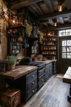 an old fashioned kitchen with many pots and pans hanging from the ceiling, along with wooden flooring