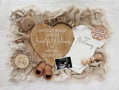 a baby's birth announcement is displayed on a blanket with shoes and other items