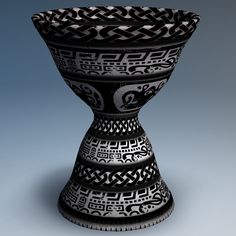 a black and white vase sitting on top of a table