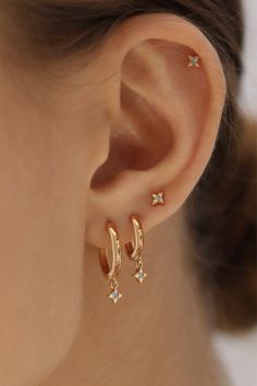 a woman's ear with two small stars on it