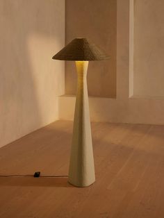 a lamp sitting on top of a wooden floor