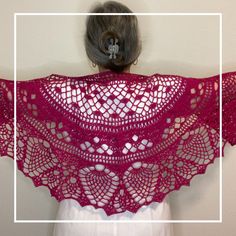 a woman wearing a red crochet shawl with an intricate design on it