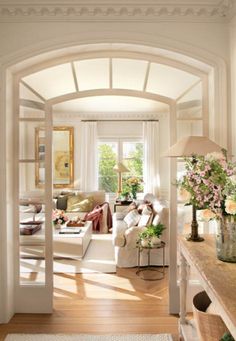 a living room filled with furniture and flowers