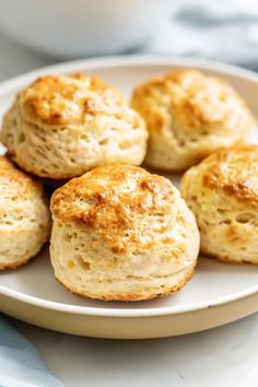 biscuits on a plate with a cup of coffee in the background