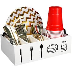 a white box filled with lots of silverware next to a red cup and fork