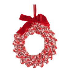 a red and white wreath hanging from the side with a bow on it's head