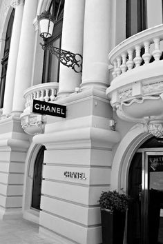 black and white photograph of the entrance to a chandelier shop in an old building