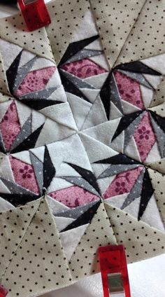 the quilts are being sewn together to make an origami star pattern