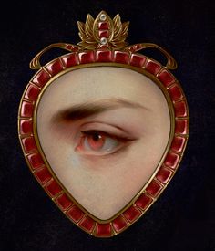 an eye is reflected in a mirror with gold trimmings and red glass accents