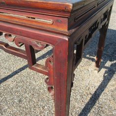 an old wooden table sitting on the ground