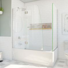 a bathroom with white tile and green trimmings on the shower door, toilet and bathtub