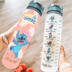 someone holding a water bottle with stitch on it