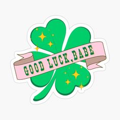 the good luck babe sticker is shown in pink, green and gold with stars on it