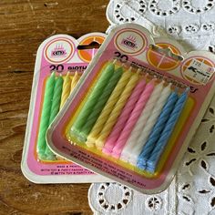 several different colored candles are in a package