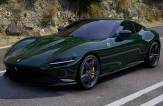 a green sports car driving down the road