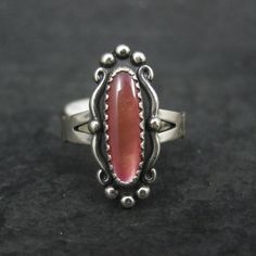 This beautiful Southwestern ring is sterling silver. It features a resin orange moonglow stone. The face of this ring measures 13/16 of an inch north to south. Marks: WM, Sterling WM is the hallmark for the William Wheeler Company Condition: Old new stock - some with tags Southwestern Sterling Silver Opal Ring, Southwestern Sterling Silver Cabochon Rings, Southwestern Sterling Silver Ring With Cabochon, Southwestern Sterling Silver Rings With Cabochon, Collectible Orange Sterling Silver Jewelry, Glow Ring, Funky Rings, Orange Moon, Gothic Victorian