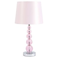 a pink lamp on a white background with a light shade in the middle and three beads at the base