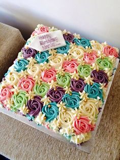 the cake is decorated with multicolored icing