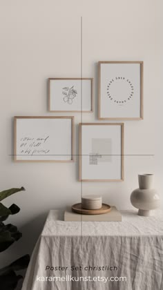 four frames hanging on the wall above a table with a vase and plant in it