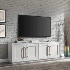 a flat screen tv mounted to the side of a white entertainment center