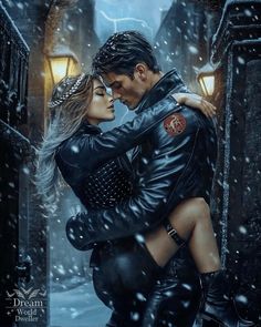 a man and woman are hugging in the snow while wearing black leather jackets with their arms around each other