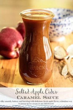 an apple cider sitting on top of a wooden cutting board