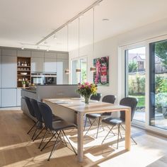 an open kitchen and dining room with sliding glass doors