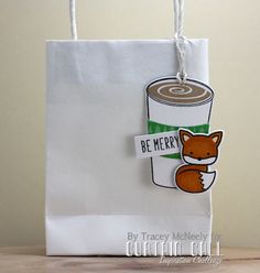 a paper bag with a sticker on it that says be merry and a cup of coffee