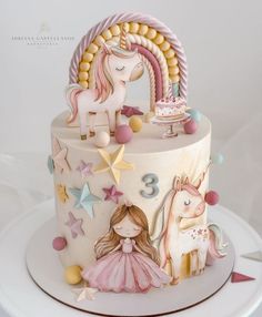 a birthday cake decorated with unicorns and stars