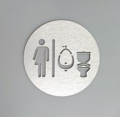 a metal sign with a man and a woman in the bathroom on it's side