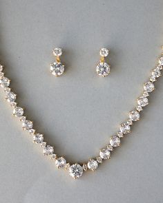 An everyday special occasion necklace style perfect for the bride or any time! Two sizes of brilliant-cut cubic zirconia alternate with small round jewels to create this spin on a classic necklace style! The length of the necklace is 17 inches and the length of the pierced earrings is .75 inches. This set is rhodium, rose gold, or gold plated with grade AAA CZ stones and is lead, cadmium, and nickel free. Sparkling Round Diamond Necklace For Wedding, Wedding Necklace Designs, Minimalist Accessories Jewellery, Bride Jewelry Set, Gold Wedding Jewelry, Diamond Necklace Set, Cz Necklace, Classic Necklace, Vintage Inspired Jewelry