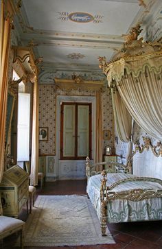 an ornately decorated bedroom with four poster bed