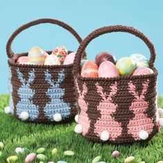 two crocheted baskets with easter eggs in them sitting on the grass next to each other