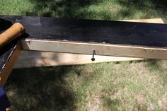 a wooden bench sitting on top of a lush green field