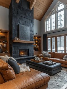 a living room with couches and a fireplace in the center, surrounded by windows