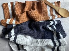 an assortment of crocheted towels and wooden spoons