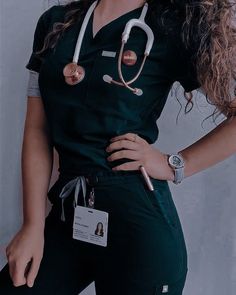 a woman in scrubs is standing with her hands on her hips and wearing a stethoscope