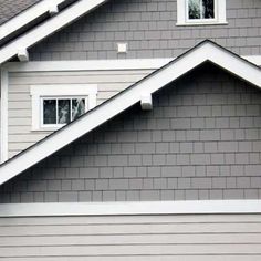 a gray house with white trim and windows