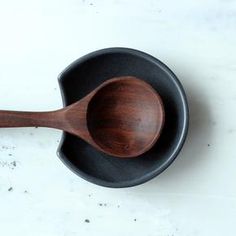 a wooden spoon in a black cast iron skillet