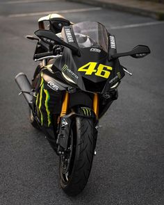 a black and yellow motorcycle parked on the street