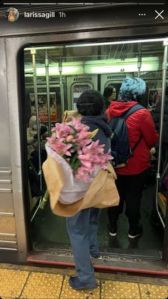 people on the subway with flowers in their hand