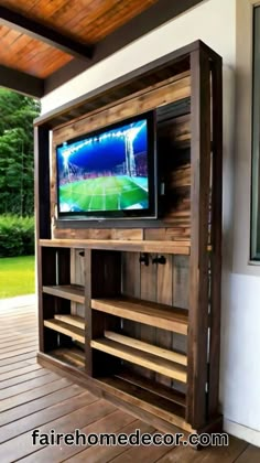 an entertainment center made out of wood with a television on it's stand and shelves