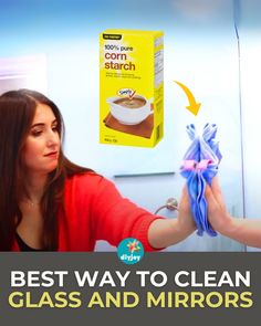 the woman is cleaning her glass and mirror