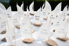 small wooden sailboats are on display for guests to view at an outdoor wedding reception